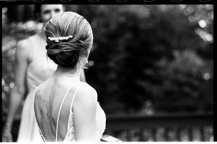 wedding bride dress hair back neck muscles muscular woman she her johnny martyr looking away glancing away bokeh focus rangefinder 35mm film black and white unconventional photojournalism documentary portrait beauty girl woman beautiful moment